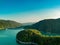 Aerial drone shot of a scenic reservoir with forested hills on the coasts