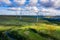 Aerial drone shot of several clean energy wind turbines