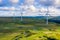 Aerial drone shot of several clean energy wind turbines in a rural area of South Wales, UK