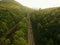 Aerial Drone shot of truck driving down a road in the misty Adirondack Mountains.