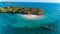 Aerial drone shot of the untouched Fumba island with an approaching boat in Zanzibar, Tanzania