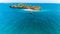 Aerial drone shot of the untouched Fumba island with an approaching boat in Zanzibar, Tanzania