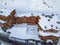 Aerial drone shot view of wooden chalet with heavy snow in Val Thorens ski resort
