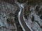 Aerial drone shot of winding road through the mountains.