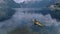 Aerial drone shot of yellow kayak in fjord water