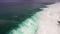 Aerial drone slow motion footage of ocean waves breaking before the shore. Bali, Indonesia