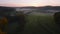 Aerial drone Sunrise view Above autumn colored forest and Valleys in Luxembourg, covered in morning fog