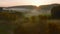 Aerial drone Sunrise view Above autumn colored forest and Valleys in Luxembourg, covered in morning fog