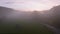 Aerial drone Sunrise view Above autumn colored forest and Valleys in Luxembourg, covered in morning fog