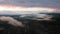 Aerial drone sunrise view over foggy countryside with wooden houses