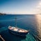 Aerial drone top down photo of beautiful red fishing boat anchored in small paradise island of Monolia in small