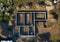 Aerial drone top down view on construction site with reinforced concrete house foundation, brick wall and materials like wall