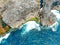 Aerial drone top view of coral beach and blue ocean waves In Nusa Penida, Bali, Indonesia. Overhead View Of Rocky Coast And Coves