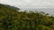 Aerial drone top view of exotic paradise tropical coastal cliff with volcanic stones covered with green jungle