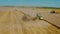 Aerial drone top view harvesting machine cutting down ripe wheat crop ready to be transported and refined. V7