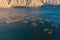 Aerial drone top view of sea fish farm cages and fishing nets, farming dorado, sea bream and sea bass, feeding the fish a forage,