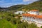 Aerial drone top view to countryside summer landscape with white residential houses among green olive garden hills and blue sky