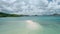 Aerial drone - tourist banca boat moored at sandbar during low tide. Surrounded islands and white clouds moving n