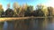 Aerial drone video in mid-air panning from right to left over the river with colorful trees of Autumn