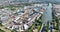 Aerial drone video of the port of Nijmegen industrial zone with docks and companies.
