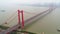 Aerial drone video, red suspension bridge with traffic flowing across