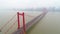 Aerial drone video, red suspension bridge with traffic flowing across