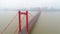 Aerial drone video, red suspension bridge with traffic flowing across