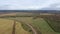 Aerial drone view agriculture crops wheat filed with road and cars. Highway road through field and meadow Landscape. Top