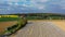 Aerial drone view of asparagus fields and yellow rapeseed fields in German countryside.