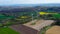 Aerial drone view of asparagus fields and yellow rapeseed fields in German countryside.