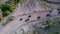 Aerial drone view of ATV quads on a dirt trail in forests. Off-road group team club enthusiasts having fun while driving