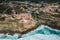Aerial drone view of Azenhas do Mar, a small Portuguese village situated on edge of steep cliff in a stunning location on