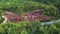 Aerial, drone view of beautiful road forest in Cheltenham Badlands Canada landscape, road, bridge, shot flying over a green forest