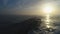 Aerial drone view of beautiful sunrise over the sea waves and old broken bridge