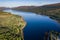 Aerial drone view of a beautiful, tranquil Scottish loch in the early morning sunshine Loch Eil, Fort William