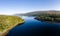 Aerial drone view of a beautiful, tranquil Scottish loch in the early morning sunshine Loch Eil, Fort William
