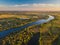 Aerial drone view. The bend of a wide river among green meadows