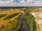 Aerial drone view. The bend of a wide river among green meadows