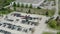 Aerial drone view of the car carrier trailer car hauler loads cars on the trailer, on parking of the dealer lot
