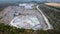 Aerial drone view of career in Europe, crushed stone quarry at summer sunset