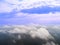 Aerial Drone view clouds over the green forest and lake. Low lying cloud. Aerial view of over tropical rainforest. Above the cloud