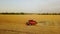 Aerial drone view: combine harvesters working in wheat field on sunset. Harvesting machine driver cutting crop in