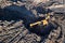 Aerial drone view of excavator loading the tipper truck