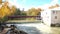 Aerial drone view flying at low angle view away from the bridge at Legare Mill in St-Eustache, revealing the surrounding scenery