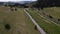 Aerial drone view following a camper driving in sunny, summer day. Caravan trip into the wild.