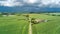 Aerial drone view of green fields and farm houses near canal, typical Dutch landscape, Holland, Netherlands