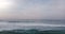 Aerial drone view of high waves in beautiful sunset ocean. Breathtaking open ocean, cloudy sky and horizon panorama.