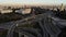 Aerial drone view of highway multi-level junction road with moving cars at sunset. Cars are moving on a multi-level road