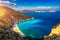 Aerial drone view of iconic turquoise and sapphire bay and beach of Myrtos, Kefalonia (Cephalonia) island, Ionian, Greece. Myrtos