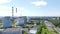 Aerial drone view of industrial landscape, the pipes of the thermal power station with smoke, high voltage tower